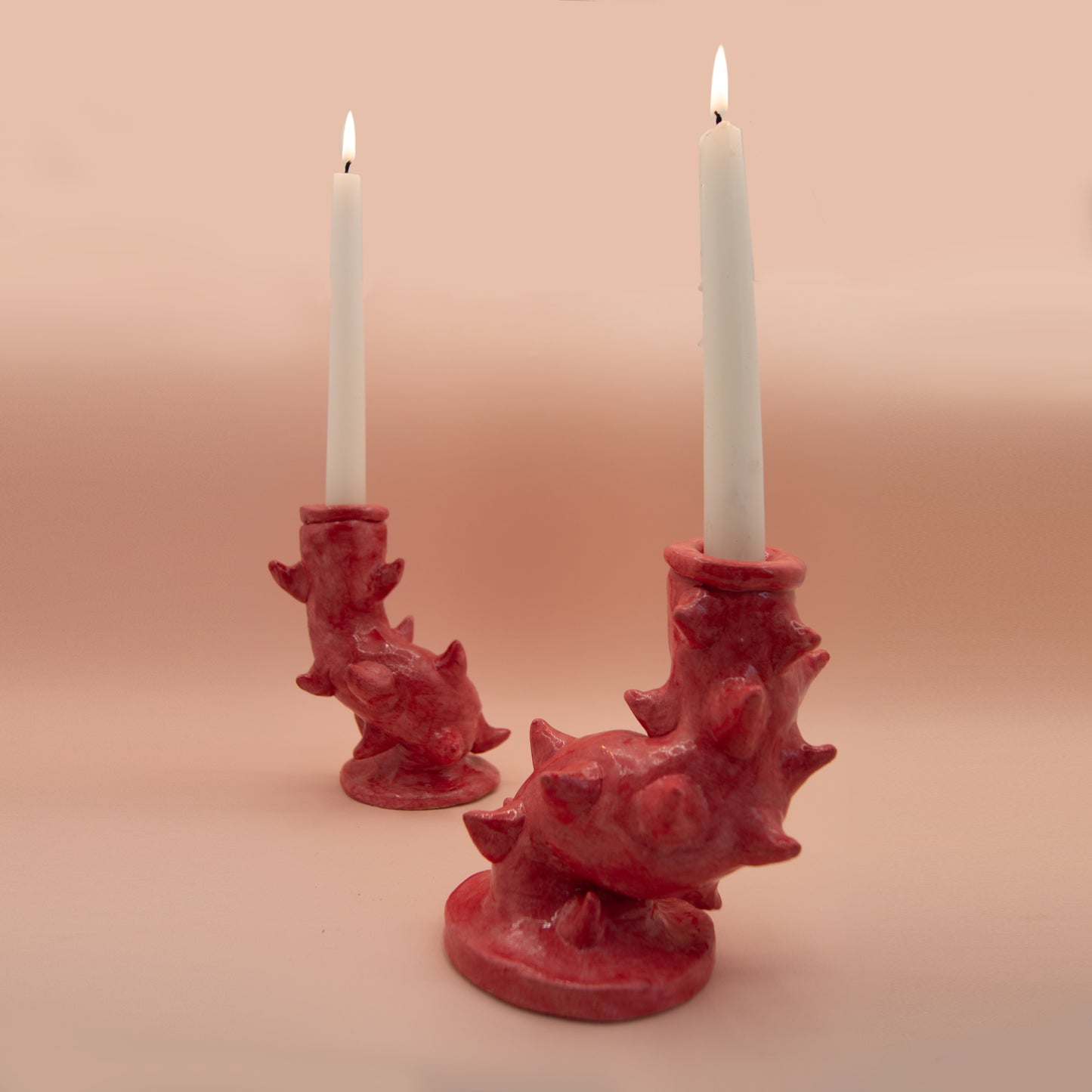 Red candlesticks with ceramic thorns