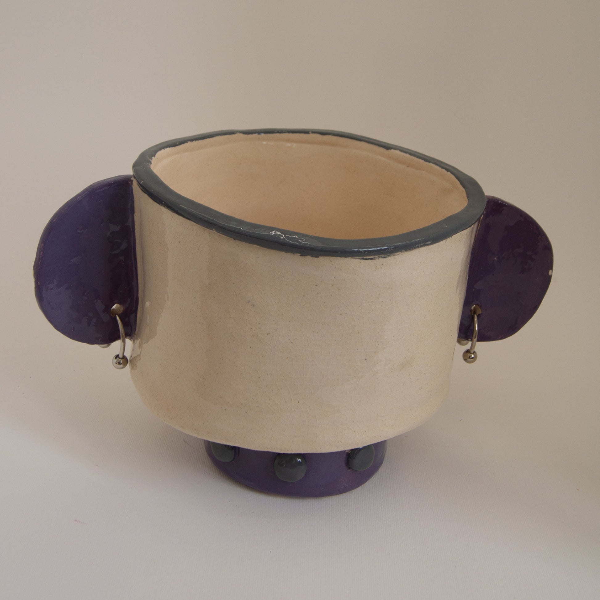 Purple ceramic vase with pierced ears