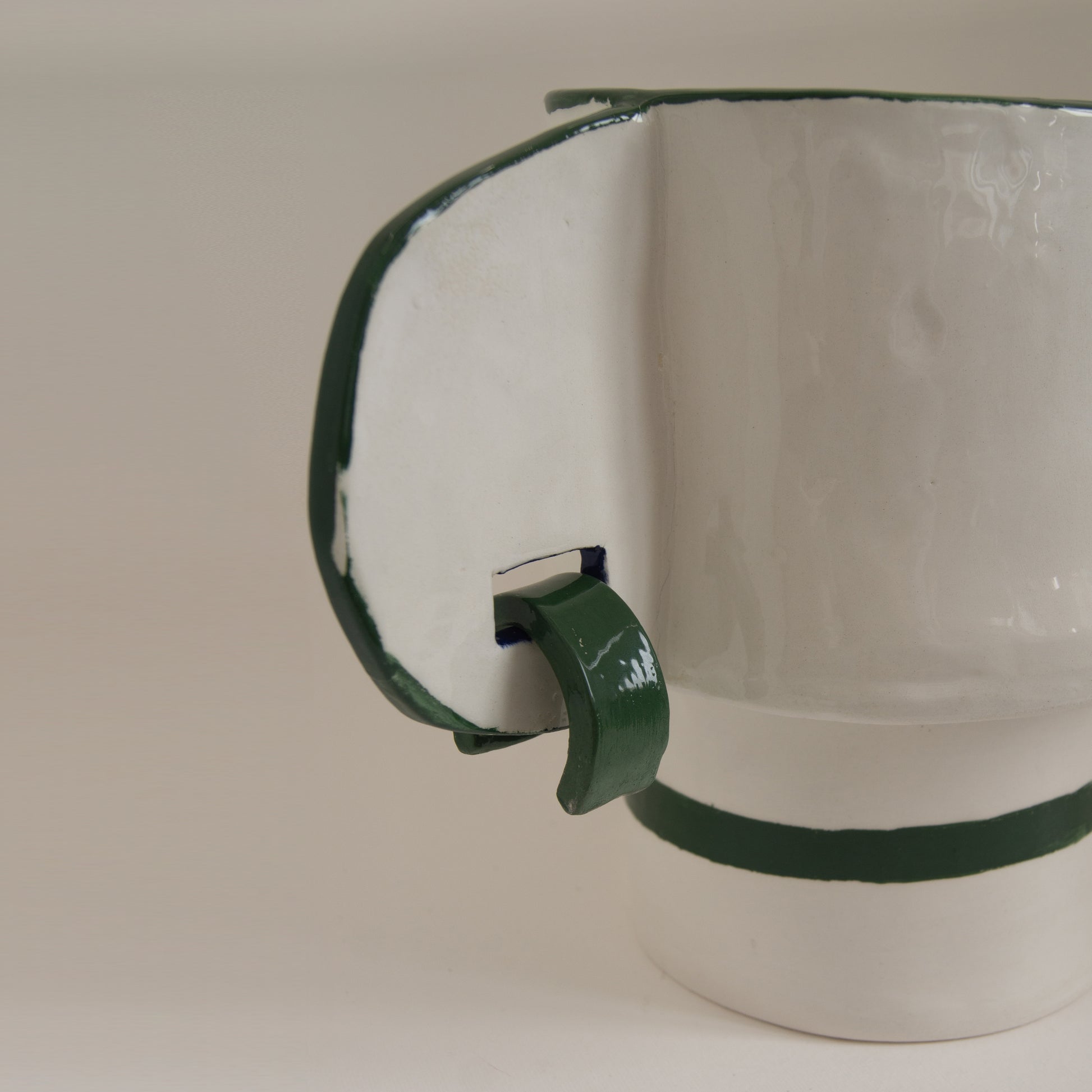 Handcrafted vase with unique ear motifs and glossy finish.