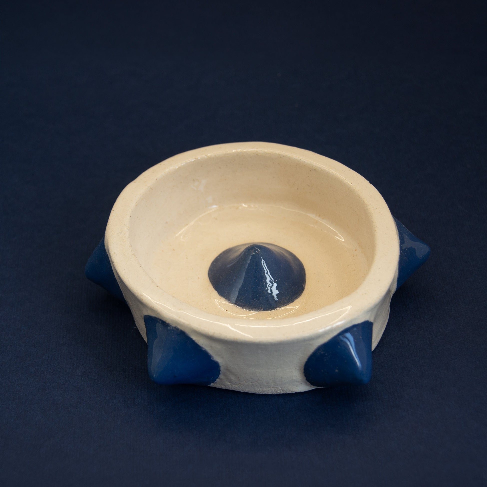 white and blue ceramic ashtray with edgy, sculptural design.