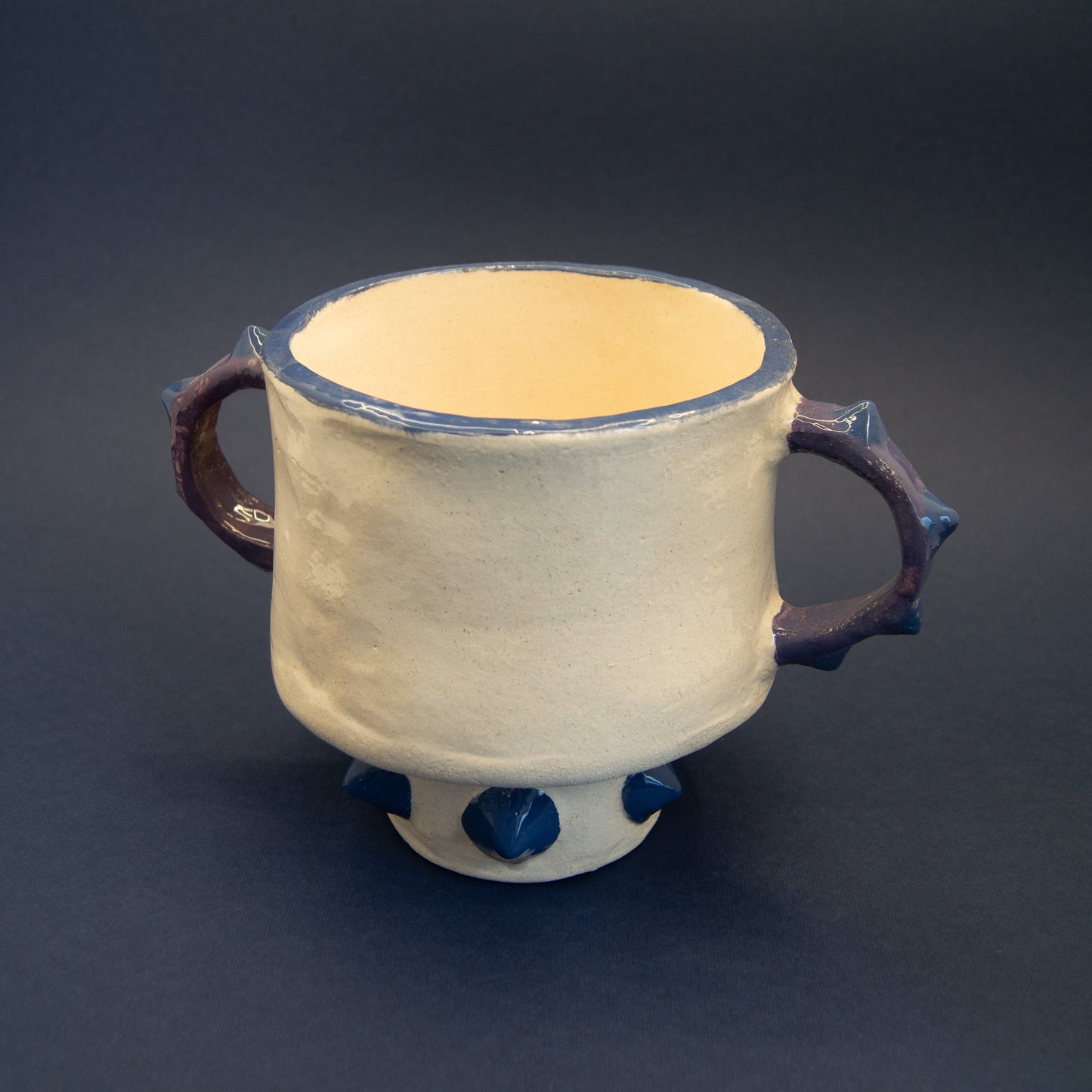 Large ceramic vase with bold, sculptural design.