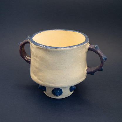 Large ceramic vase with bold, sculptural design.