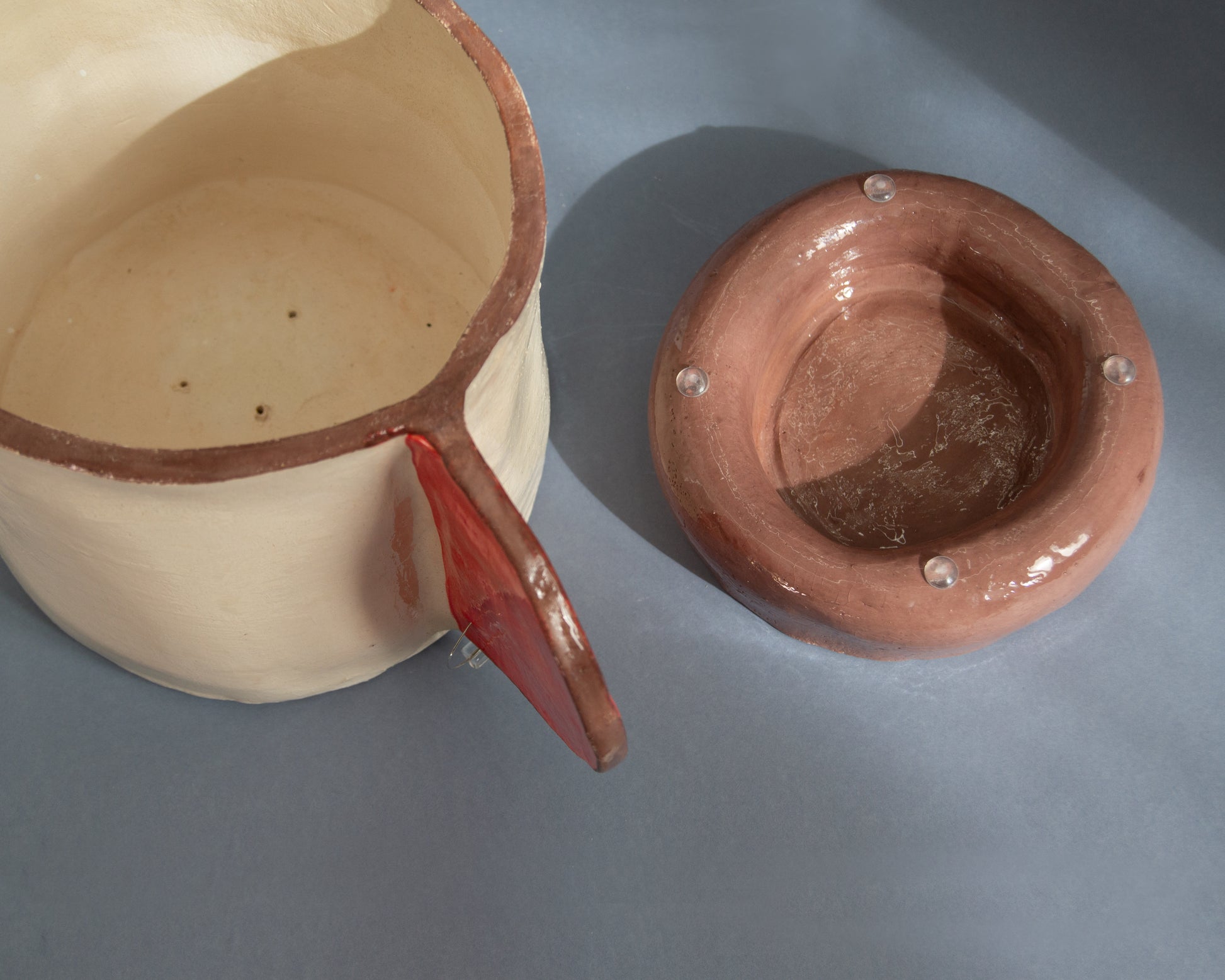 Red and brown listening vase plant pot with saucer features drainage holes, elegant design, perfect for indoor plants.