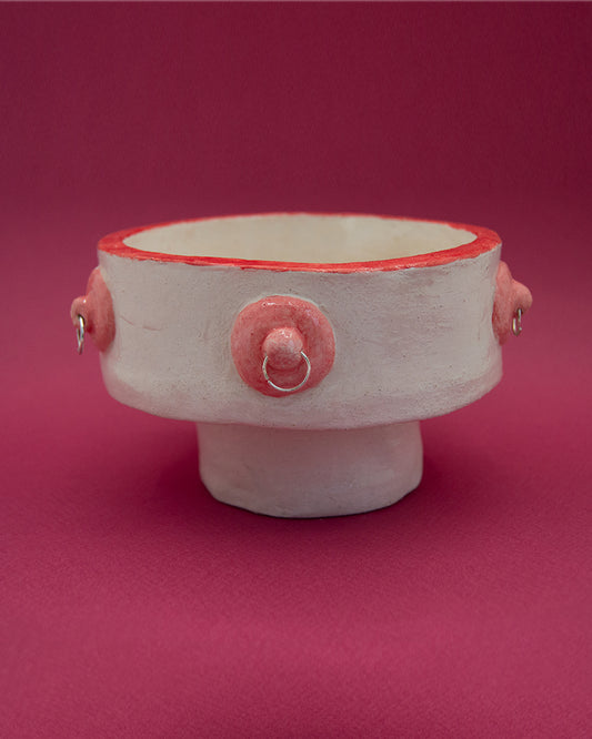 Unique valet bowl with nipple and piercing decor, diameter 16 cm, height 10 cm, on a pink background.